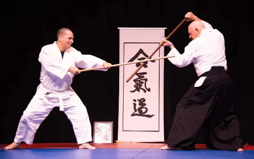a couple of men in karate uniforms