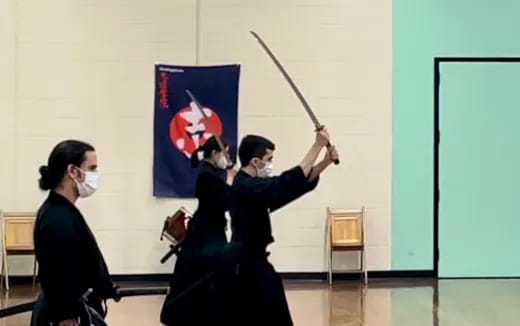 a group of people in masks holding swords