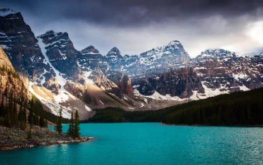a lake with snowy mountains