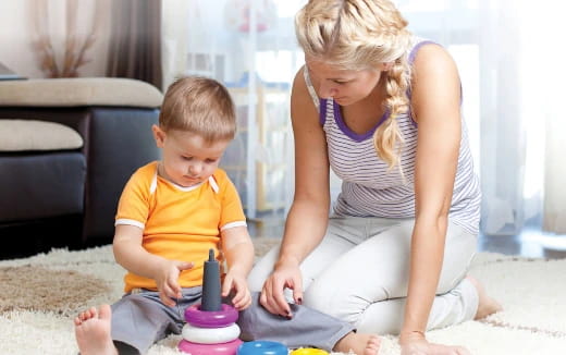 a person and a boy playing with a toy