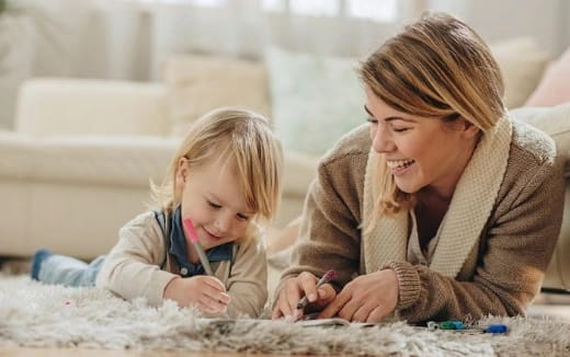a woman and a child playing with a toy