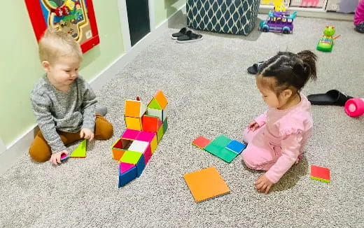 a couple of children playing with toys