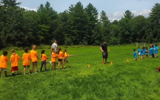 a group of kids playing in a field