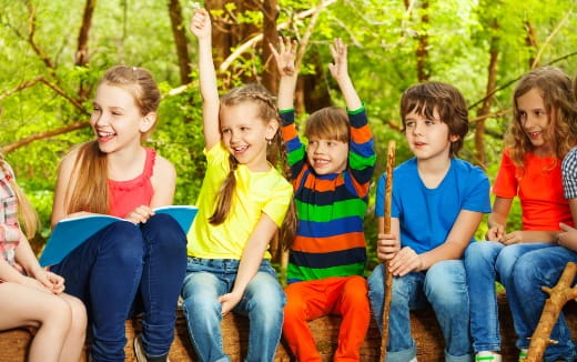 a group of children sitting on a bench