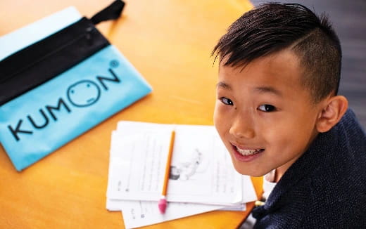 a boy sitting at a desk