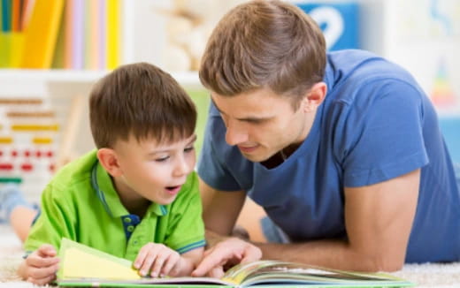 a person and a boy looking at a book