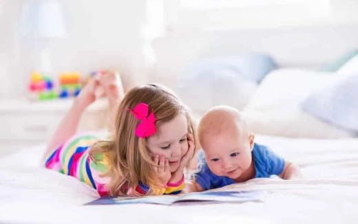 a baby and a baby lying on a bed