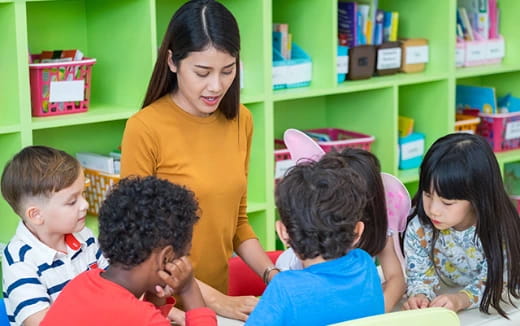 a person and several children in a classroom