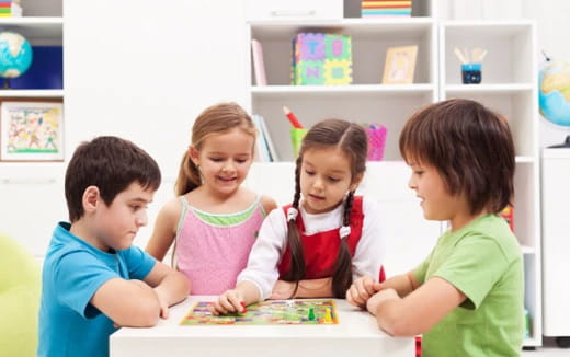 a group of children playing a board game