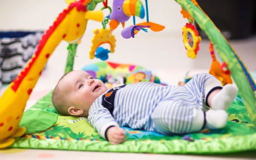 a baby lying on a blanket