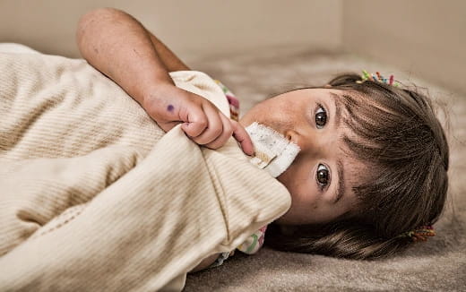 a person lying on a bed