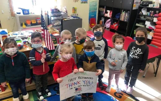 a group of children holding a sign