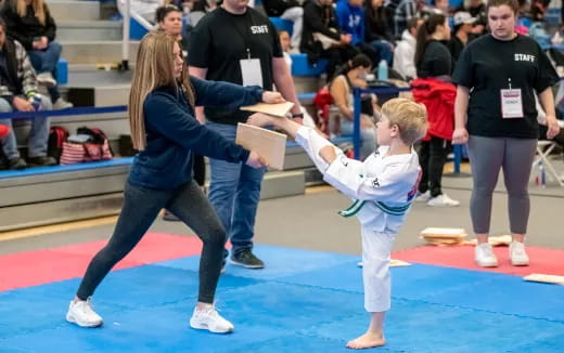 a person and a child in karate uniforms