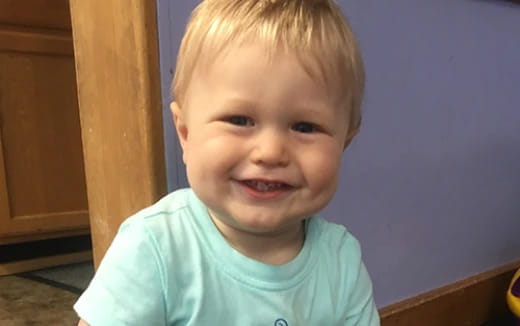 a boy smiling for the camera