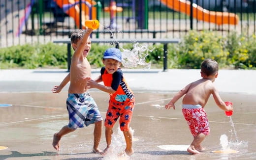 a group of children playing in the water