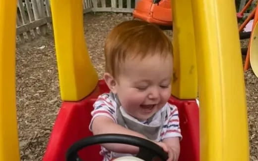 a baby in a red chair