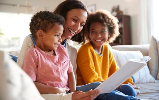 a family looking at a laptop