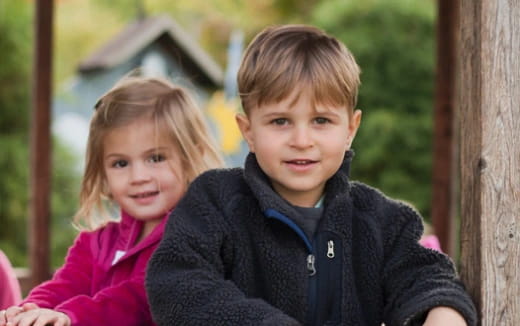 a boy and girl posing for a picture
