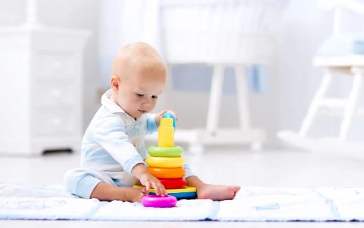 a baby playing with a toy