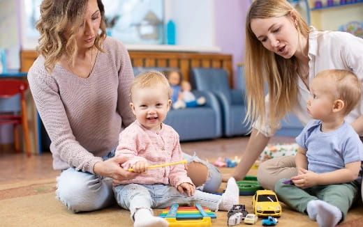 a person and two children playing with toys