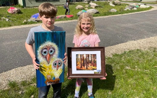 a boy and girl holding a picture
