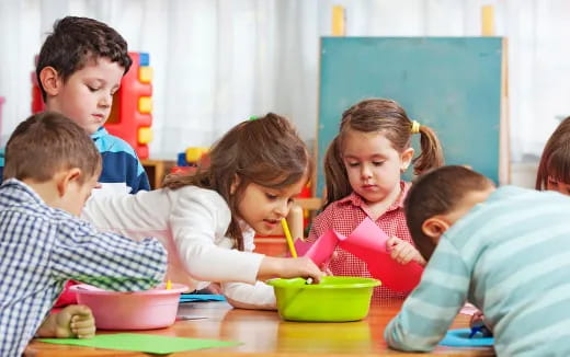 a group of children sitting at a table