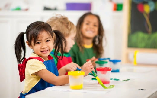 a group of children sitting at a table