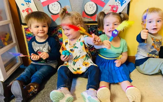 a group of kids sitting on the floor eating candy