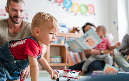 a person reading a book to a child