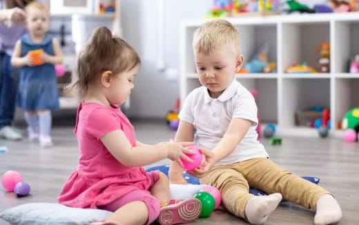 a couple of children playing with toys