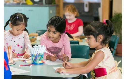 a group of children sitting at a table