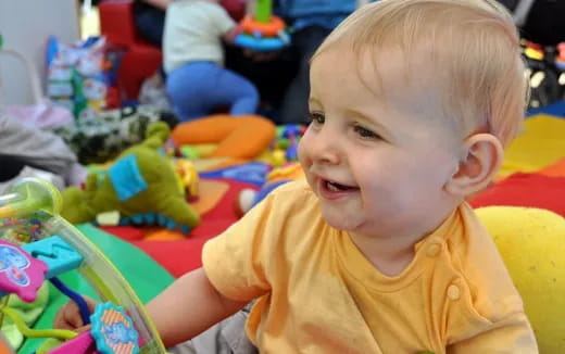 a baby smiling at the camera