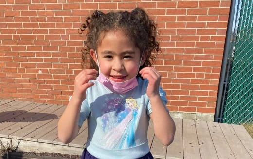 a little girl with curly hair