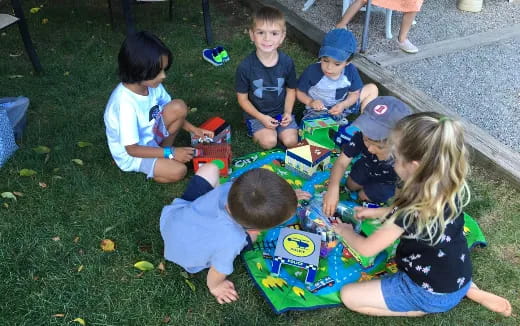 a group of children playing on the grass