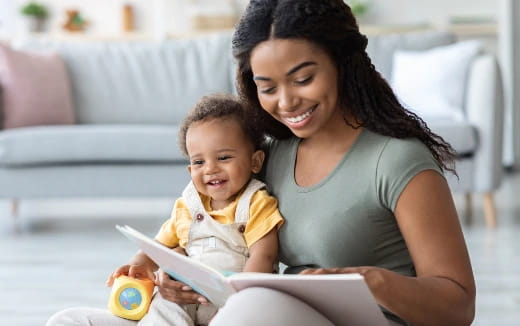 a person reading a book to a baby