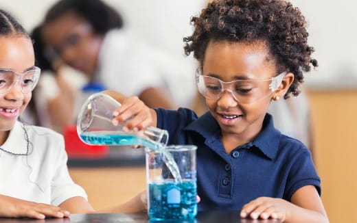 medium shot of kids using a microscope