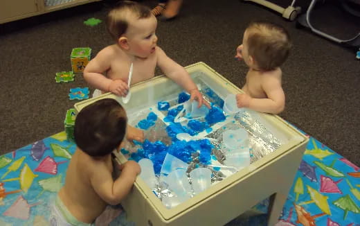 a group of babies playing with toys