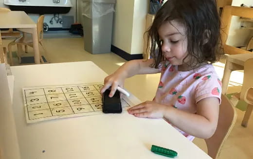a girl using a computer mouse