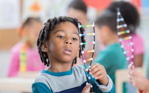 a young girl holding a pencil