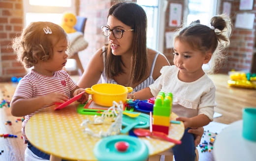 a person and two children playing with toys