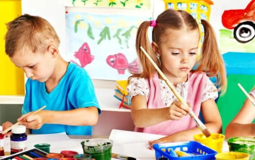 a young girl and a young boy painting