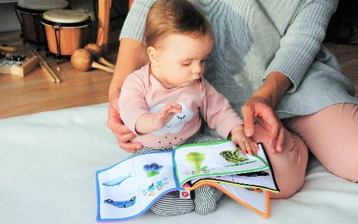 a person and a baby playing with a puzzle