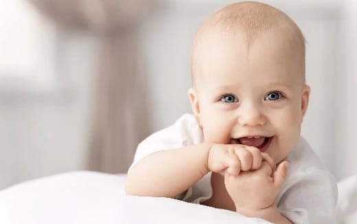 a baby with a hand on its chin