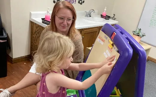 a person holding a child's hair
