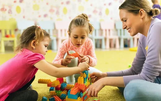 a woman and two children playing with a toy
