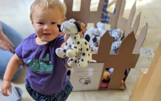 a child holding a stuffed animal