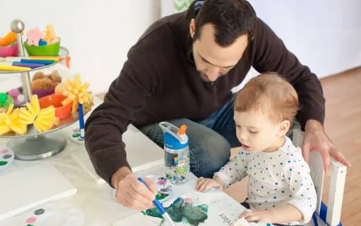 a person and a child painting