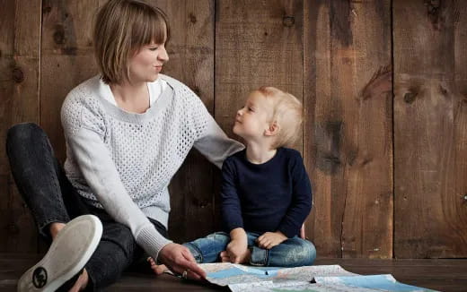 a person and a child sitting on the ground
