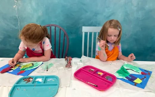 a couple of young girls painting