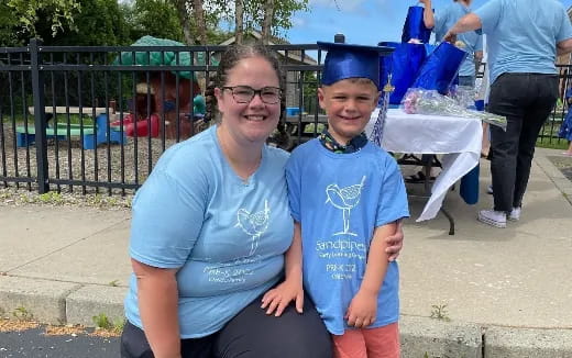 a person and a boy posing for a picture